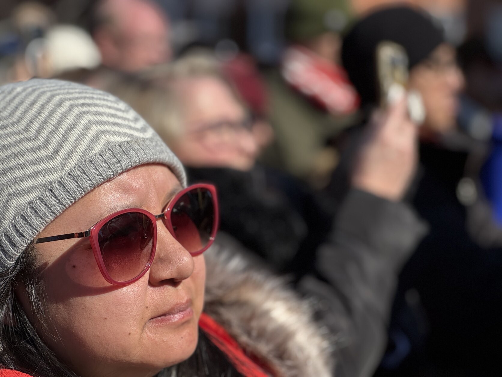 A woman joins a crowd in Alexandria in listening to the monks' message on Feb. 9, 2026.