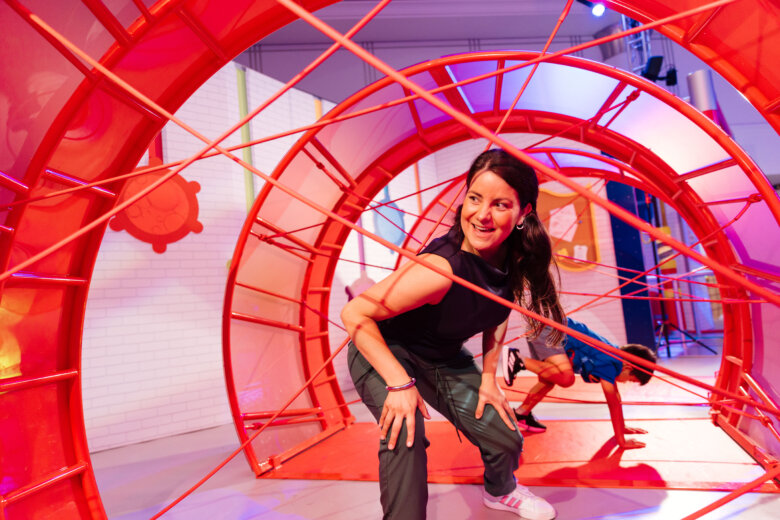 woman navigating obstacles in brightly colored room