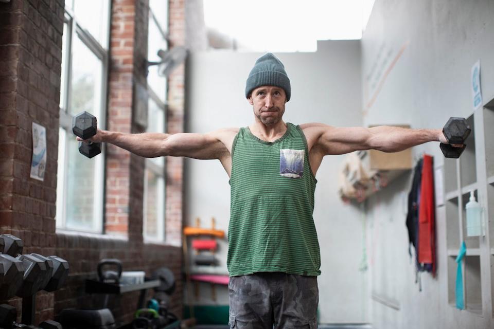 muscular man exercising withnbspdumbbellsnbspin gym