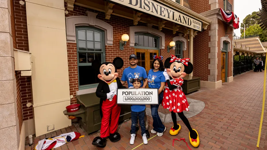 Eight-year-old Andres Robles of Arizona celebrates after being named Disneyland's honorary one billionth guest during a surprise ceremony at the California theme park.