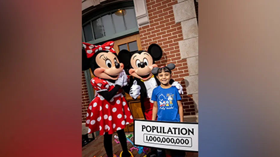 Mickey Mouse and Minnie Mouse greet 8-year-old Andres Robles