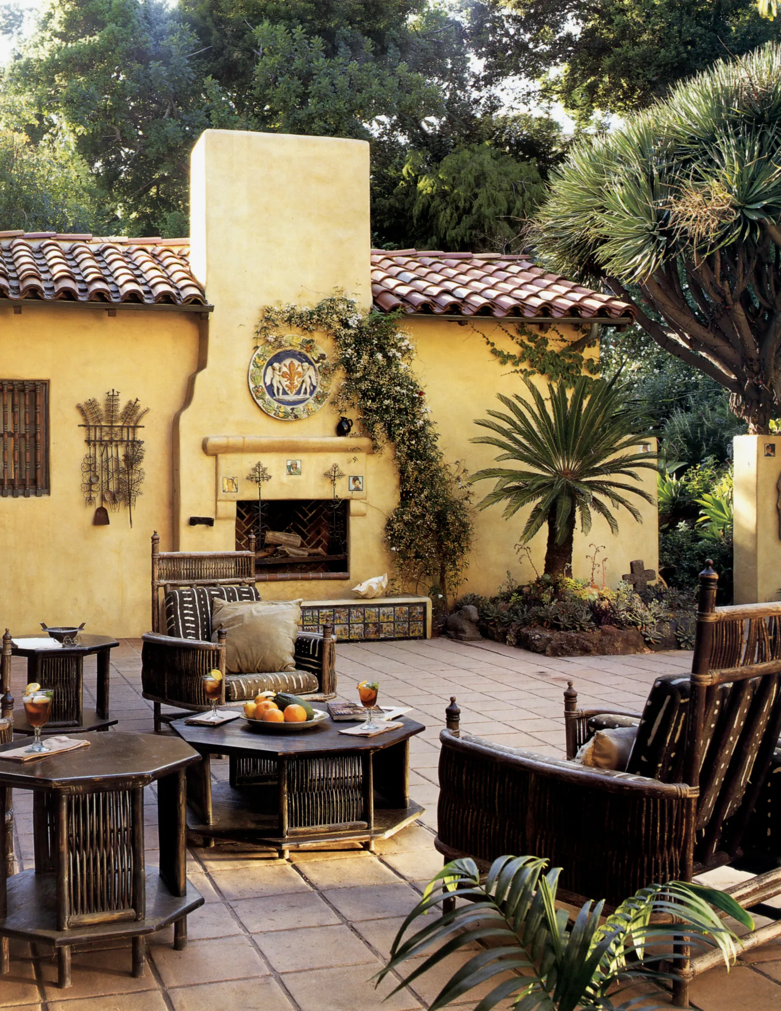yellow exterior wall and red tiled roof fireplace tiled patio seating