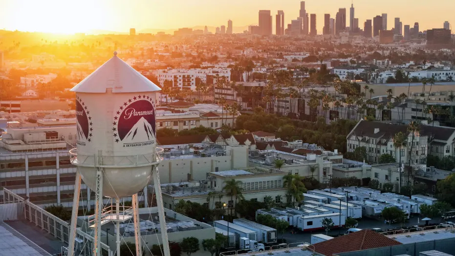 The sun rises behind the water tower at Paramount Studios.